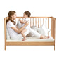 Parent and toddler on a cot bed with Golden Fleece bamboo bedding