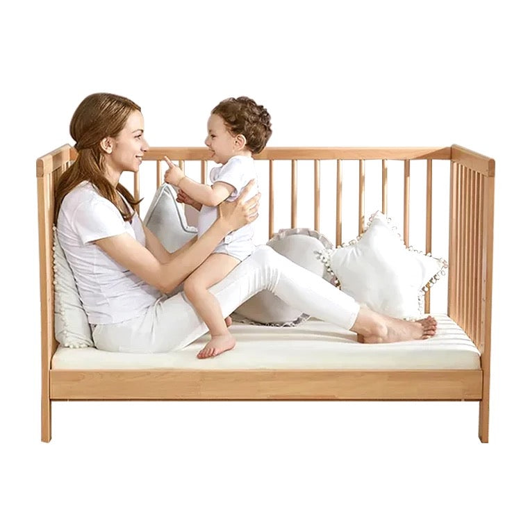 Parent and toddler on a cot bed with Golden Fleece bamboo bedding
