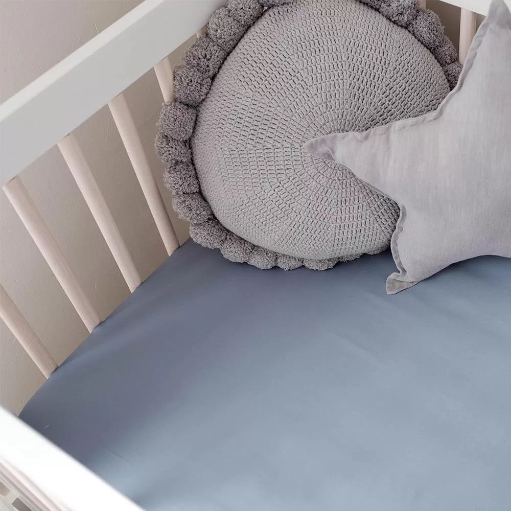 Light Blue bamboo fitted sheet on a cot bed